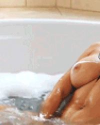 Hot busty babe masturbates in the bathtub